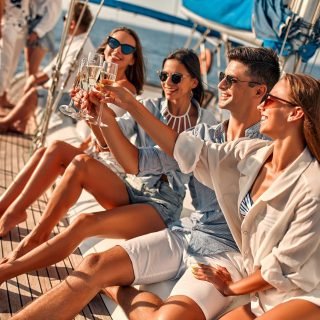 Group,Of,Friends,Relaxing,On,Luxury,Yacht,And,Drinking,Champagne.