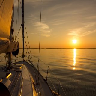 Sailing,Into,The,Sunset.,Yacht,With,Sails,And,Sunset